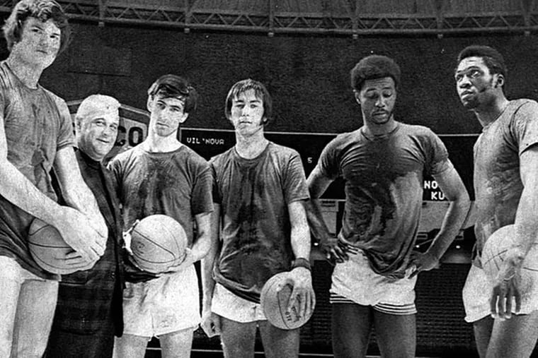 In this 1971 photo, Villanova college basketball coach Jack Kraft, second from left, poses with members of his team, from left: Hank Siemiontkowski, Kraft, guards Tom Ingelsby and Chris Ford, and forwards Howard Porter and Clarence Smith. (Staff file photo)