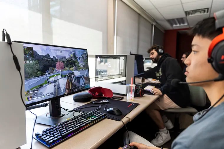 Stephen Nackman, 21, plays "Apex Legends" with his college esports team at Temple. He is the controller player and "fragger," meaning he is focused on killing enemy opponents and usually dies first within the game. Behind him sits Luca Rizzolo, 19, who brought his own keyboard.