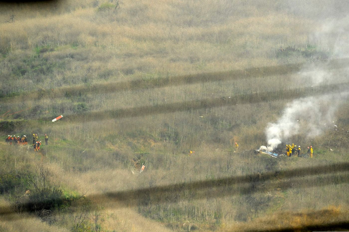 Firefighters work at the scene of the crash site Sunday.