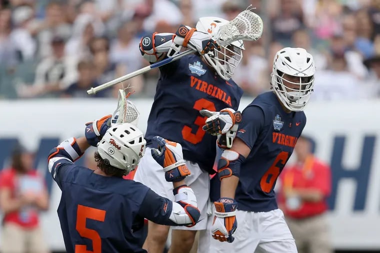 Virginia's Dox Aitken (6) celebrates his fourth-quarter goal with teammates Matt Moore (5) and Ian Laviano (3) during the semifinal win over Duke.