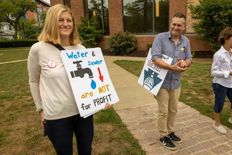 Ginny Marcille-Kerslake, an organizer with Food and Water Watch and David McMahon, of Neighbors Opposing Privatization Efforts, during rally opposing the privatization of the Bucks County sewer system in Doylestown earlier this month.