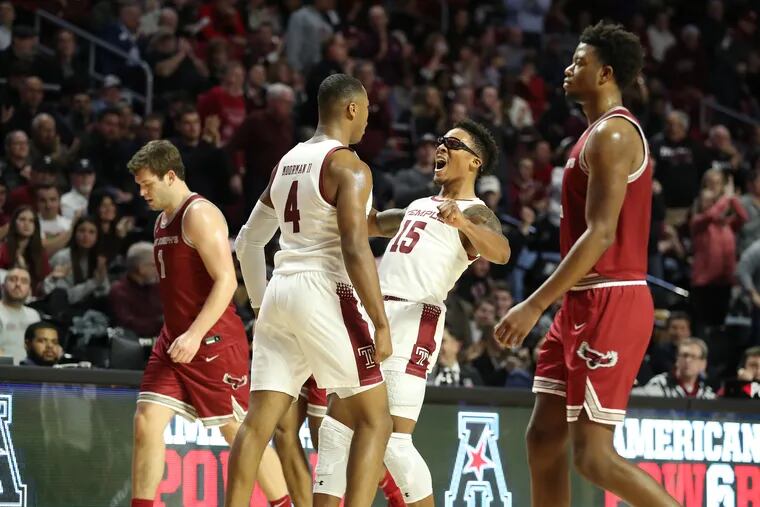 JP Moorman, 2nd, from left, and Nate Pierre-Louis, 3rd from left, of Temple  celebrate at the end of the 1st half as St. Joseph’s players walk off the court on Dec. 10, 2019.