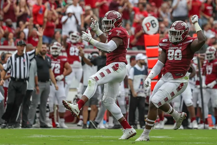 Temple DT Ifeanyi Maijeh (88) and defensive end Quincy Roche (left) celebrate a sack against Maryland.