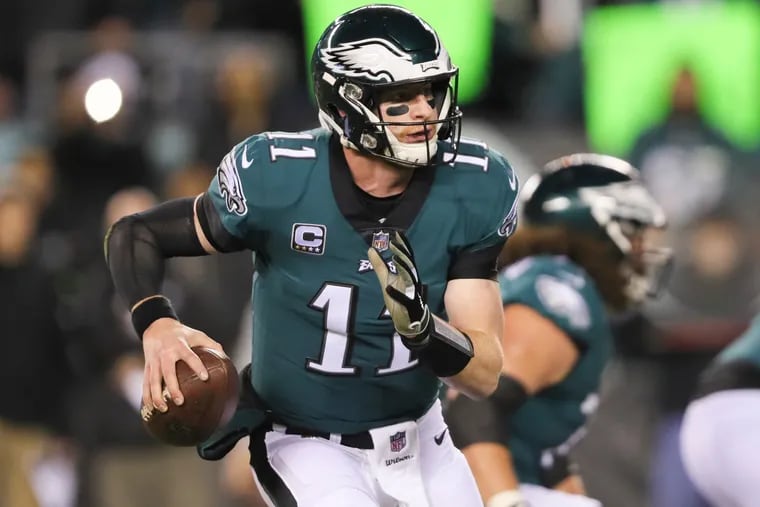 Eagles quarterback Carson Wentz scrambles with the football in the first-quarter against Washington on Monday, December 3, 2018 in Philadelphia. (DAVID MAIALETTI / Staff Photographer)