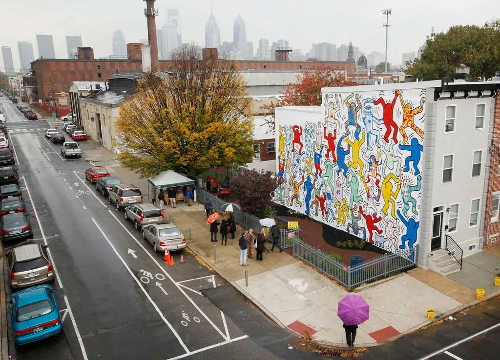 "We the Youth," a Keith Haring mural at 22nd and Ellsworth Streets, has been restored to its original vibrancy and will be maintained by the Philadelphia Mural Arts Program.