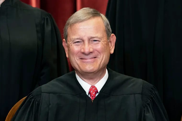 Chief Justice John Roberts sits during a group photo at the Supreme Court in Washington, April 23, 2021.