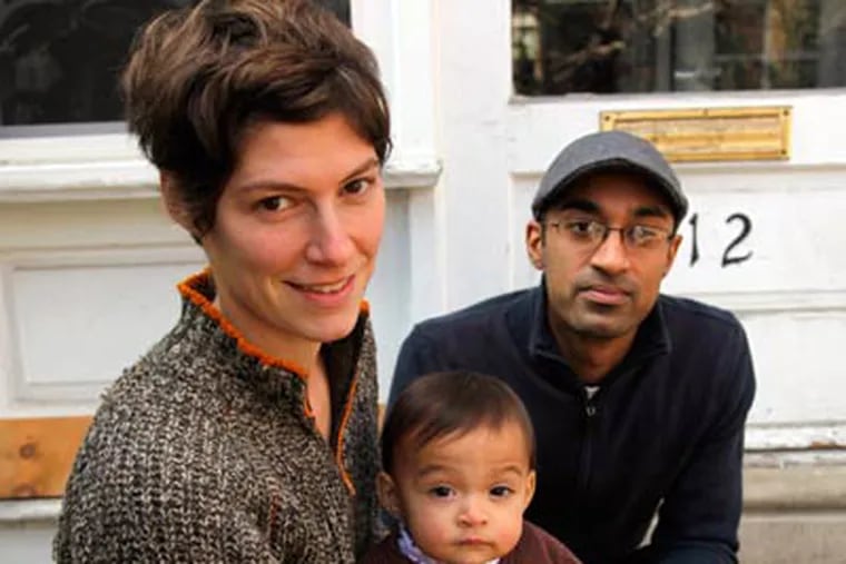 Elyse Fenton with husband Peenesh Shah and their daughter, Mira Shah, at their West Philadelphia home. (Laurence Kesterson / Staff Photographer)