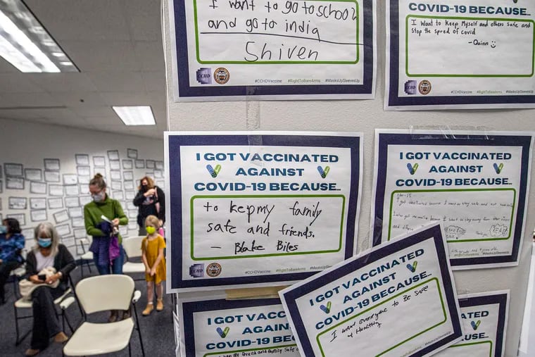Messages from kids are posted on the wall after their COVID-19 vaccine shots at the Chester County Government Services Center in December. Even younger kids are now eligible for the vaccinations.