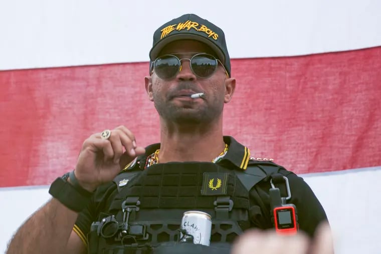 In this Sept. 26, 2020 photo, Proud Boys leader Henry "Enrique" Tarrio wears a hat that says "The War Boys" during a rally in Portland, Ore.