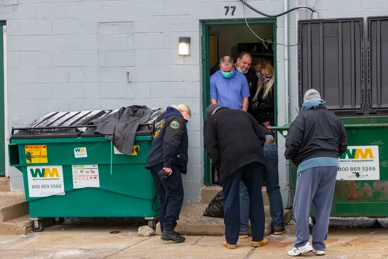 Philadelphia police detectives and Crime Scene Unit officers at the dumpsters behind businesses at Bustleton Somerton Shopping Center on Friday morning. Police are still investigating the homicide in the Somerset neighborhood where the operator of a U-Haul truck was stopped Thursday morning and body parts were found inside.