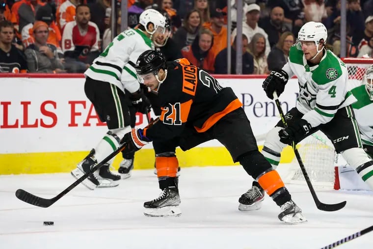 Flyers center Scott Laughton controls the puck during the first period against the Dallas Stars on Sunday.