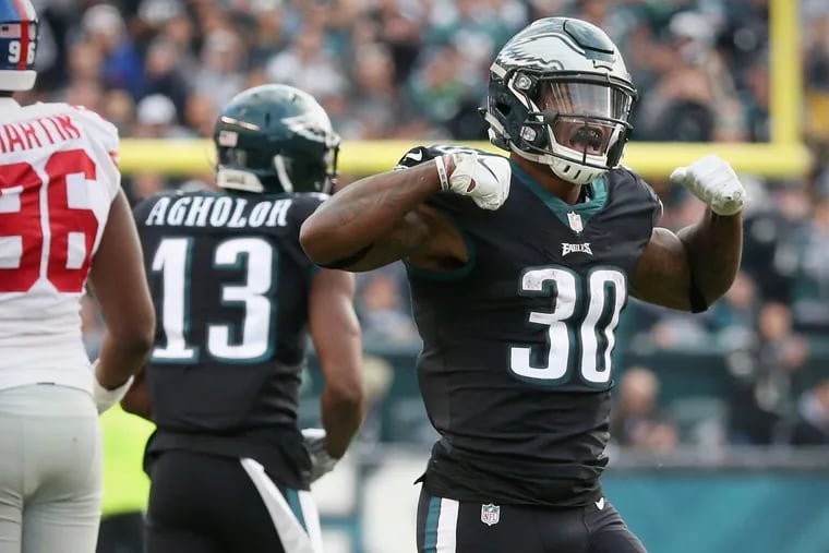 Corey Clement flexes after running for a first down against the Giants.