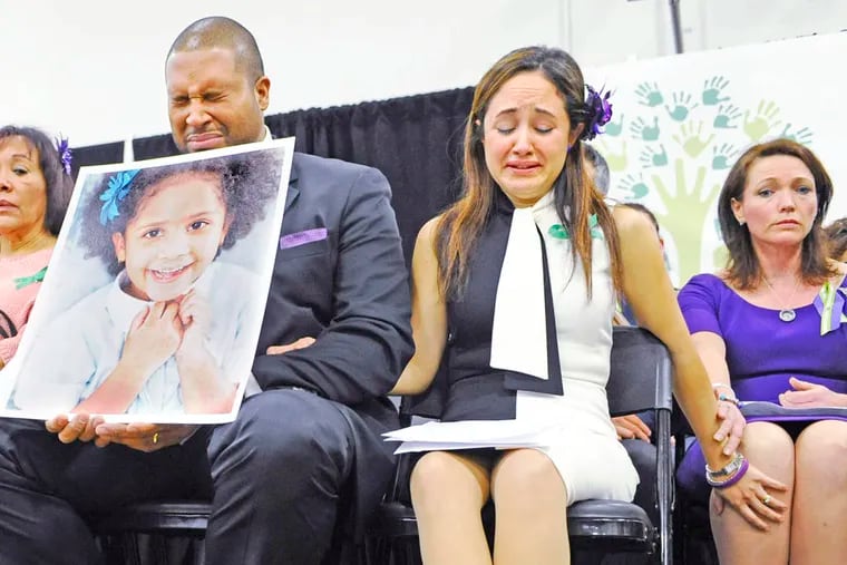 Jimmy Greene, left,  Nelba Marquez-Greene, center, parents of Sandy Hook School shooting victim Ana Marquez-Greene and Nicole Hockley, mother of victim Dylan Hockley, right, react during a news conference at Edmond Town Hall in Newtown, Conn., Monday, Jan. 14, 2013. One month after the mass school shooting at Sandy Hook Elementary School, the parents joined a grassroots initiative called Sandy Hook Promise to support solutions for a safer community. (AP Photo/Jessica Hill)