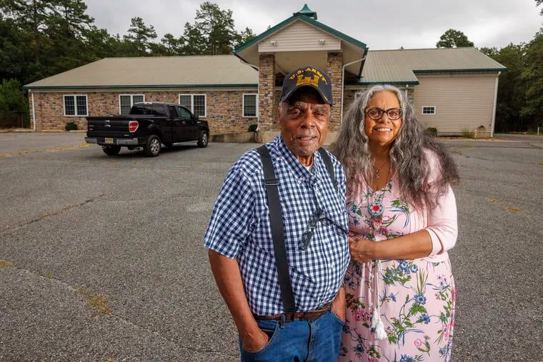 Mark "Quiet Hawk" Gould and his daughter Tyrese Gould Jacinto in front of a former church, whose 63-acre wooded property the Native American Advancement Corp. just acquired. The parcel has been renamed the Cohanzick Nature Reserve.