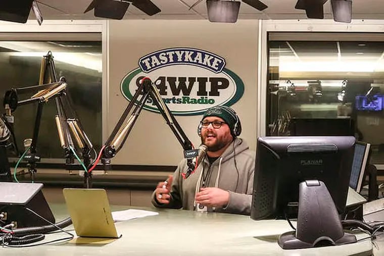 New WIP talk show host Josh Innes, a new and already very popular sports talk radio host, in the studio working. He's very animated and Stern-like on air. Wednesday,  February 12, 2014.  (  Steven M. Falk / Staff Photographer )