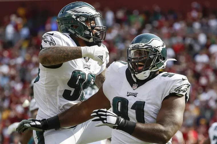 Eagles defensive tackle Fletcher Cox celebrates his touchdown fumble recovery with first-round pick Derek Barnett. The defensive front was in control for most of the game.