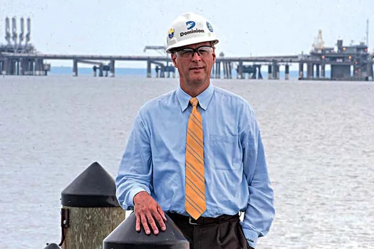 Michael D. Frederick, vice president of LNG operations for Dominion Resources, stands on a dock on shore with the massive LNG import terminal behind him, one mile out into the Chesapeake Bay on July 9, 2014.  Dominion wants to turn the import terminal into an export terminal to ship excess natural gas from the Marcellus Shale to other countries.  ( CLEM MURRAY / Staff Photographer )