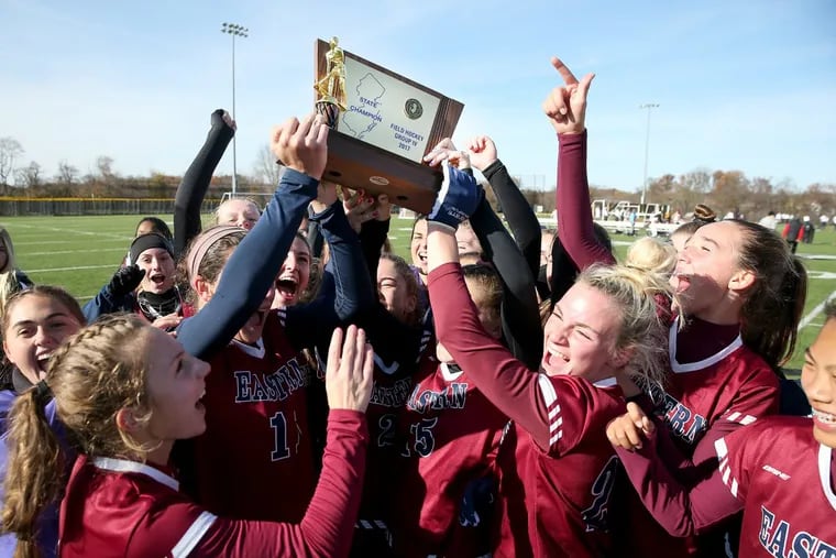 The  Eastern field hockey team celebrate winning the state championship on Saturday.