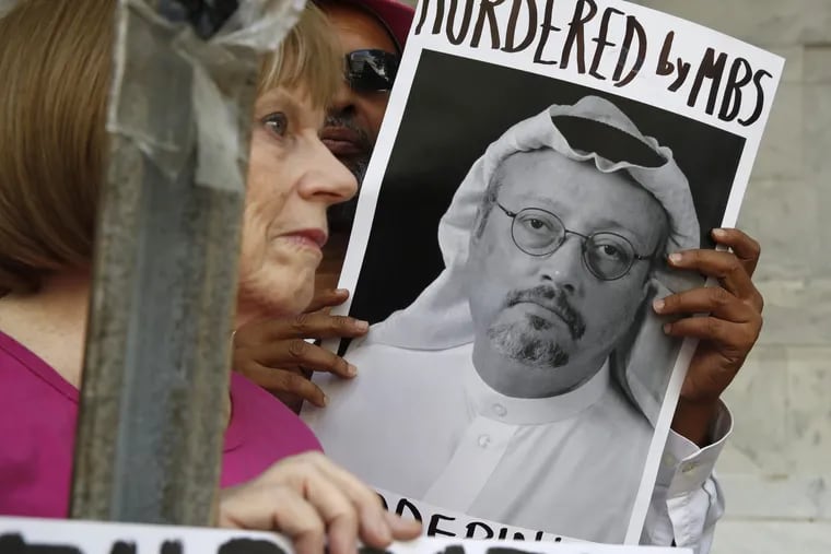 People hold signs during a protest about the disappearance of journalist Jamal Khashoggi, at the Embassy of Saudi Arabia in  Washington on Wednesday.