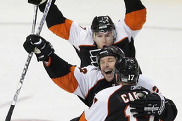 Mike Knuble, the man in the middle and the Flyers&#0039; man of the hour, celebrates his big goal.The tally gave the Flyers command of their opening-round playoff series against the Capitals.