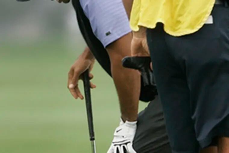 Tiger Woods holding his ailing knee.Golf&#0039;s superstar deserves good health.