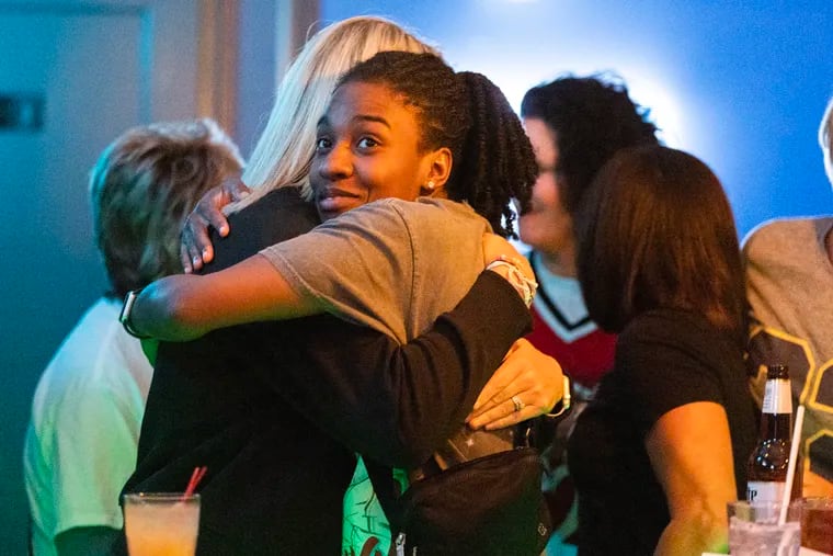 Drexel great Keishana Washington is hugged by her former coach Amy Mallon, the women's coach at Drexel.  The event was part of WatchPartyPHL, a new monthly watch party that pops up at different bars across the city to encourage people to watch more women's sports. 