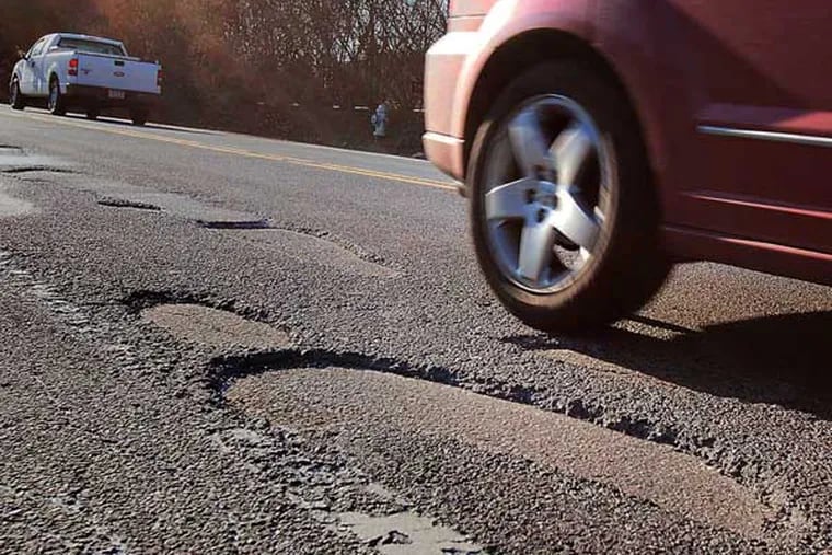 A car bounces through a series of potholes on Rt 352 in Gradyville Pa.
