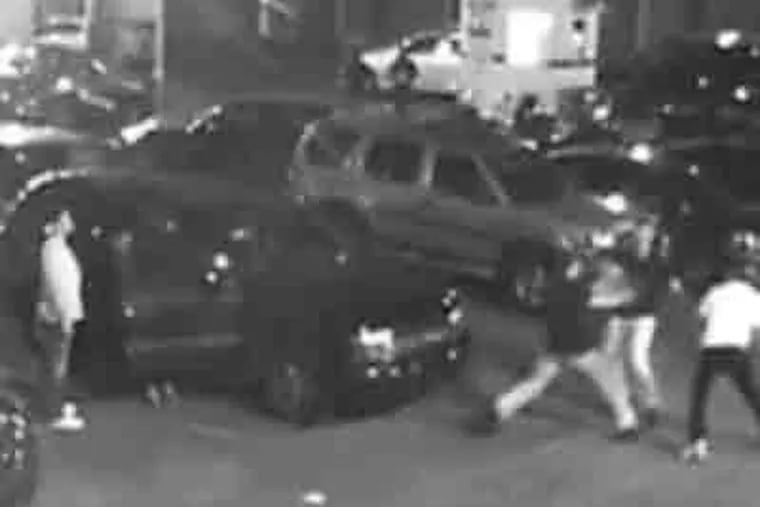 Police released this video of the attack on two friends in a parking lot by three men.