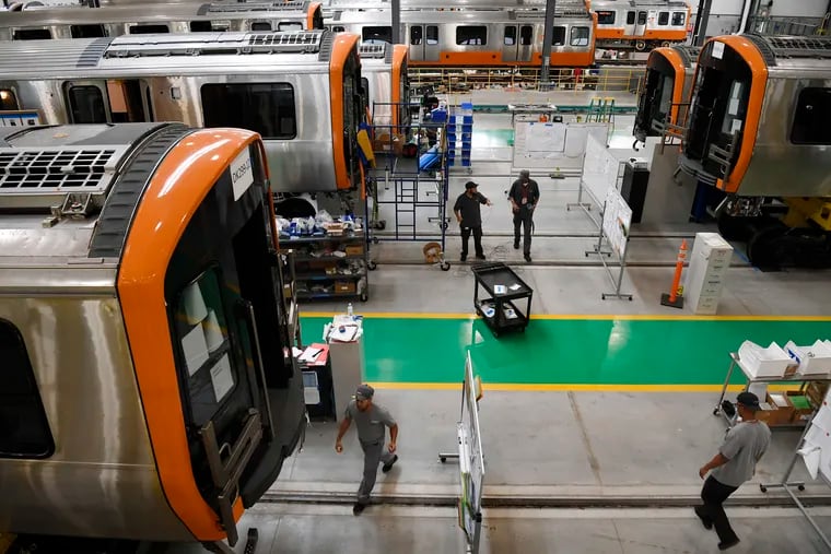 Employees work on rail cars for Boston's Orange and Red Line T fleets at CRRC in Springfield, Mass. CRRC, the company manufacturing SEPTA's new rail cars.