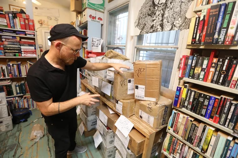 Keir Neuringer, a member of Philadelphia's Books Through Bars collective, sorts through packages of books that were supposed to go out to Pennsylvania prison inmates but were held back in September, 2018, after the Department of Corrections stopped allowing direct book donations.