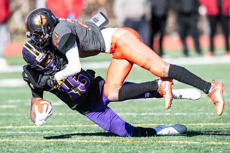 Camden's Allijah Clark gets tackled by Woodrow Wilson's Marquay Graves during a Thanksgiving Day game last year.