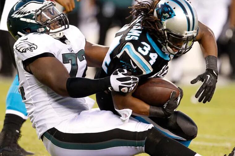 Cedric Thornton tackles Panthers running back DeAngelo Williams. (Ron Cortes/Staff Photographer)