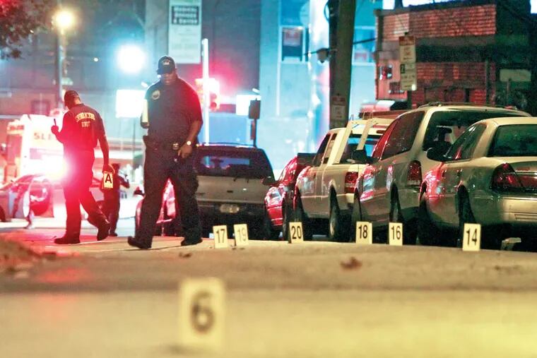 Police look over the crime scene on North Park Avenue near West Chew Avenue in the Fern Rock section of Philadelphia on Sunday Sept. 21, 2014, after four men were wounded by gunfire, two fatally. (For the Daily News/ Joseph Kaczmarek)