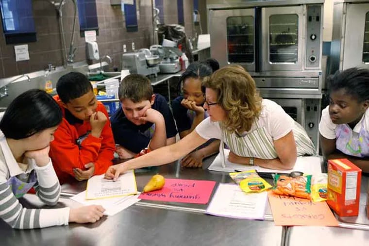 Maureen Fitzgerald discusses nutrition with Henry W. Lawton students from left,  Kimberly Luu, Nicholas Rodriguez, Christian McKinney, Nysirah Hall, and Aneza Abalo. ( MICHAEL S. WIRTZ / Staff Photographer )