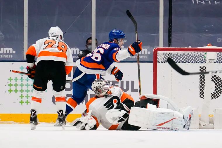The Islanders' Oliver Wahlstrom (26) celebrating his tying goal as he skates past Flyers goaltender Carter Hart (79) on Thursday night.