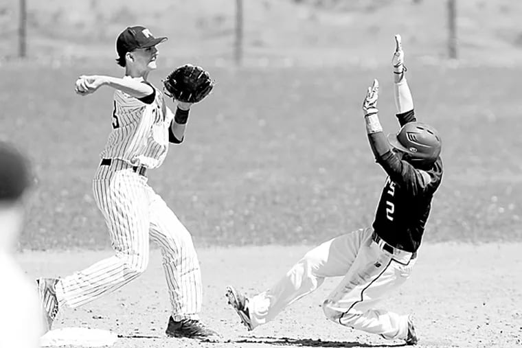 Penn Charter's Dominic Toso forces the out at second and throws to first over Bob Lukaszewski. Cardinal O'Hara loses 8-0 at Penn Charter on Saturday April 4, 2015. (David Swanson/Staff Photographer)