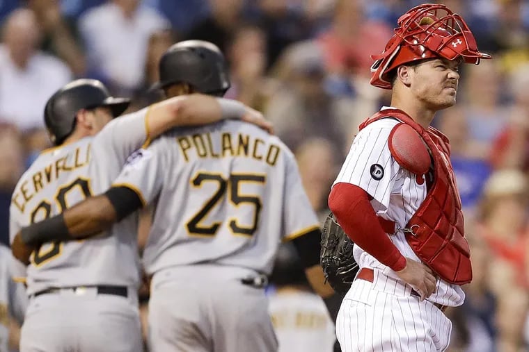 Phillies catcher Andrew Knapp stands at home plate after the Pirates' Gregory Polanco and Francisco Cervelli scored in the fourth inning.