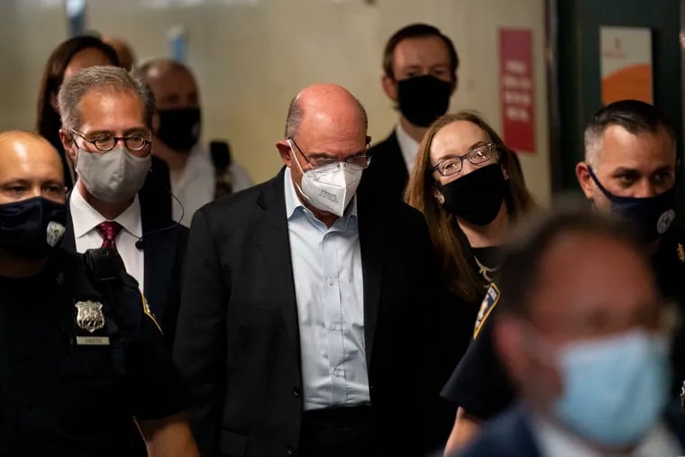 Allen Weisselberg (center), CFO of the Trump Organization, departs Manhattan criminal court on Thursday. He was arraigned a day after a grand jury returned an indictment charging him and former President Donald Trump’s company with tax crimes.
