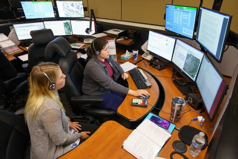 Kimberly LeBlanc, left, trains with 911 call taker Alexis Farley, right, at the Montgomery County Emergency Operations Center, in Eagleville, PA., Wednesday, August 22, 2018. In the midst of a police dispatcher shortage, the Montgomery County Department of Public Safety is holding a 4-hour, no-appointment, 911 dispatcher hiring spree from 6 a.m. to 10 a.m.