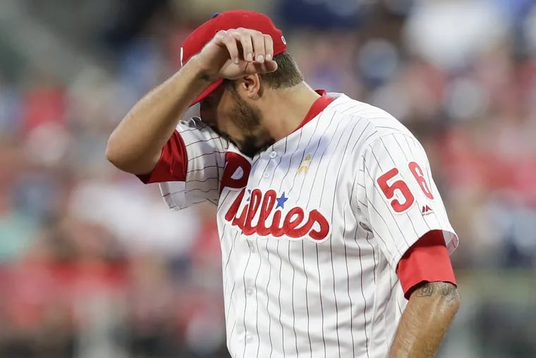 Phillies pitcher Zach Eflin wipes his face after the Chicago Cubs scored two runs in the first-inning on Saturday, September 1, 2018.