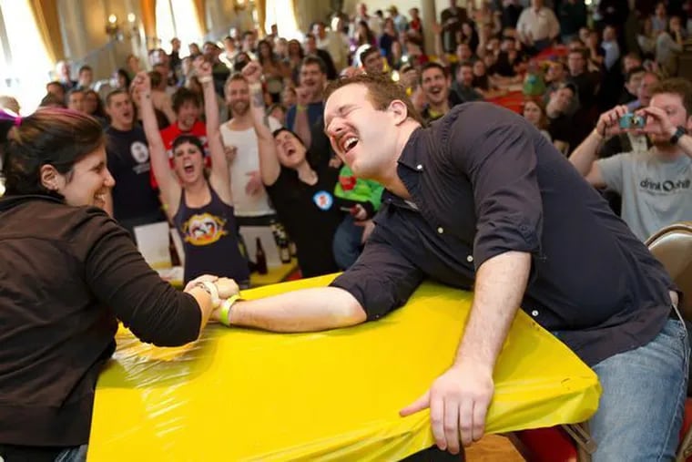 An arm wrestling match ends with excitement at Philly Bierfest.