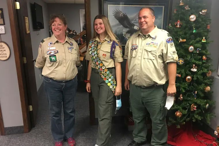 Isabella Tunney with Bev Verweg, Isabella’s scoutmaster, and Brian Reiners, the scoutmaster of the corresponding linked boy troop. Last month at age 16, Tunney became one of nearly 1,000 girls and young women honored by the Boy Scouts in a virtual celebration of the inaugural class of female Eagle Scouts. The photo was taken by Isabella’s dad, Edmund Tunney.