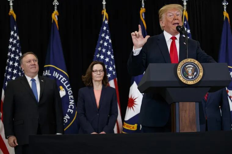 Secretary of State Mike Pompeo (left) and incoming Central Intelligence Agency director Gina Haspel listen to President Trump during a swearing-in ceremony at CIA Headquarters, Monday, May 21, 2018, in Langley, Va.
