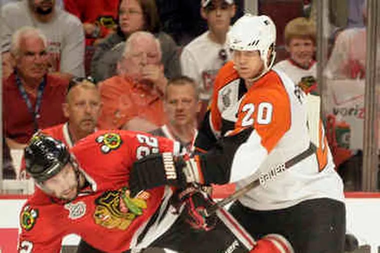 Chicago's Troy Brouwer , tangling with Flyers defenseman Chris Pronger, had two goals andone assist. He was benched for three games in the Vancouver series for lack of productivity.