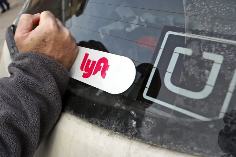 In this Jan. 31, 2018, photo, a Lyft logo is installed on a Lyft driver's car in Pittsburgh.