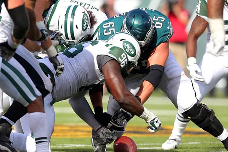New York Jets defensive endsMuhammad Wilkerson (96) and Leonard Williams (92) fight for a fumble with Philadelphia Eagles offensive tackle Lane Johnson (65) during the fourth quarter at MetLife Stadium. The Jets recovered the fumble.