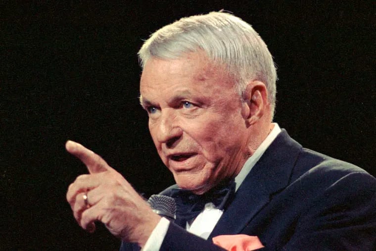 In this 1990 file photo, Frank Sinatra gestures to the crowd during a reprise of "New York, New York" at a concert in New York's Radio City Music Hall.