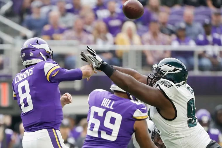Minnesota Vikings quarterback Kirk Cousins gets rid of the football against Eagles defensive tackle Fletcher Cox during the second-quarter on Sunday, October 13, 2019 in Minneapolis.