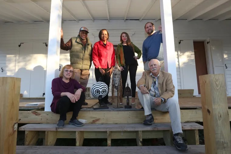 Clockwise from bottom left, Barbara Dreyfuss, trustee for the Harriet Tubman Museum, Larry Hogan, a deacon at the Macedonia Baptist Church, Lynda Anderson-Towns, trustee chairperson, Cynthia Mullock, museum executive director, Zack Mullock, construction manager, and Bob Mullock, trustee board president, on the porch of the under-construction Harriet Tubman Museum.
