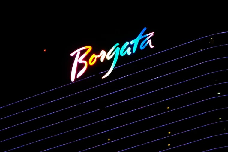 FILE - This June 24, 2016 file photo shows the illuminated logo at the top of the Borgata casino in Atlantic City, N.J.   New Jersey regulators have seized more than $107,000 won by underage or otherwise prohibited gamblers at Atlantic City's Borgata casino. The action made public recently by the state Division of Gaming Enforcement also includes an $81,000 fine for the Borgata's online gambling partner, bwin.party.